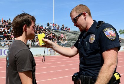 A suspect, gets a breathalyzer test from a Lemoore Police Officer.